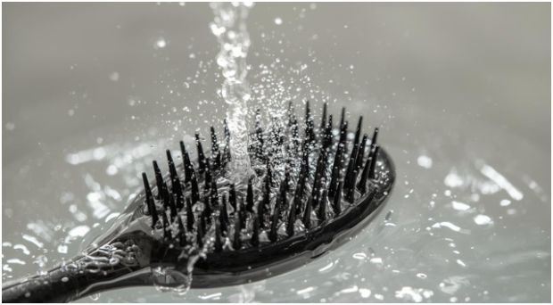 How do you clean different types of hair brushes safely?